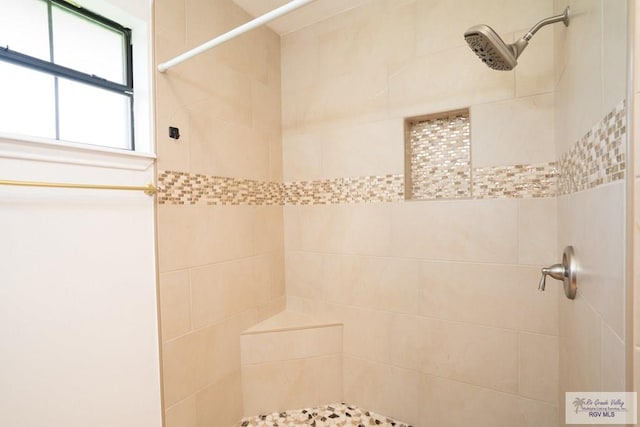 bathroom featuring a tile shower