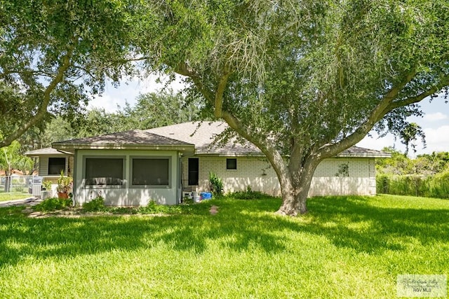 rear view of property with a lawn