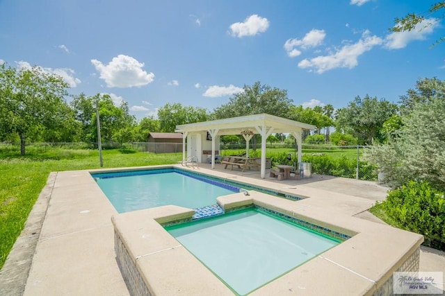 view of pool with an in ground hot tub and a patio area