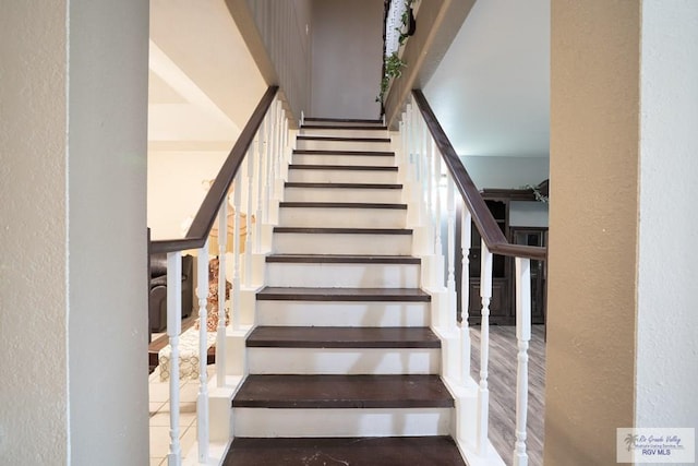 stairway with hardwood / wood-style floors