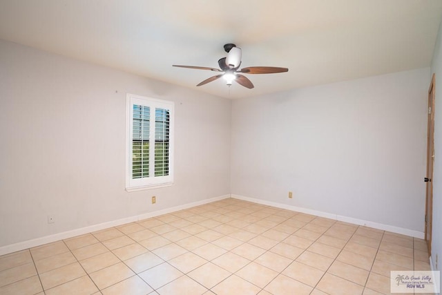 tiled empty room featuring ceiling fan