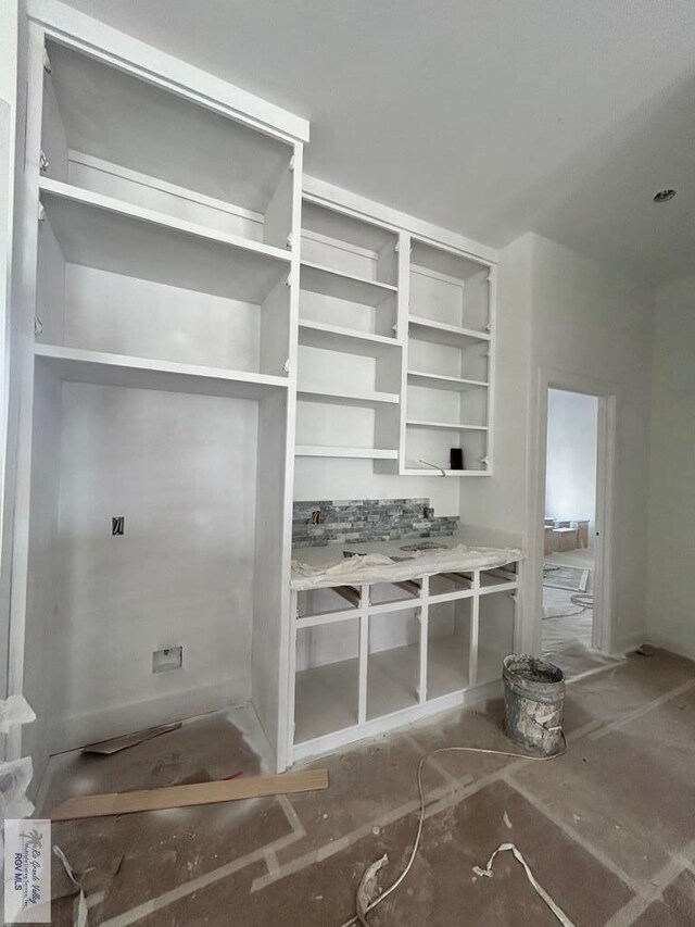 132 Finch Dr, Los Fresnos, TX 78566 - kitchen with open shelves, light marble finish floors, and a kitchen island