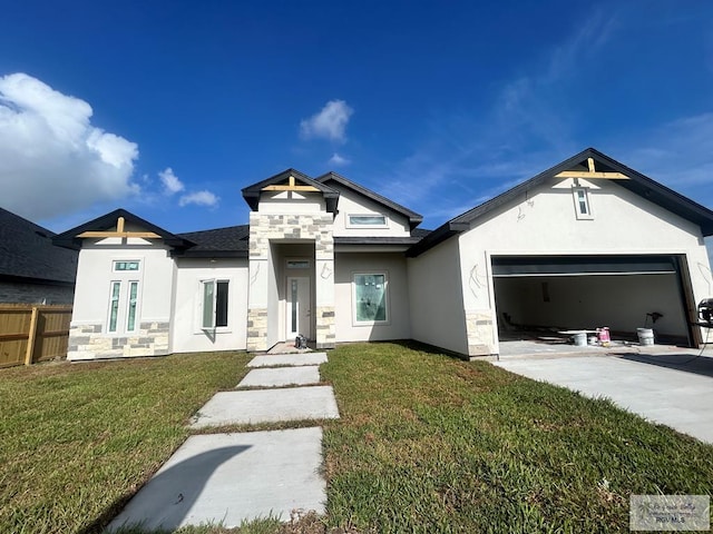 132 Finch Dr, Los Fresnos, TX 78566 - view of front of property featuring stone siding, stucco siding, an attached garage, and driveway
