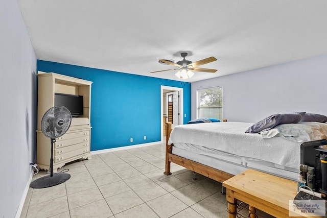 bedroom with ceiling fan and light tile patterned floors