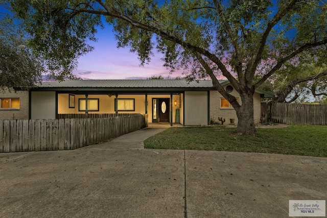 ranch-style house featuring a lawn