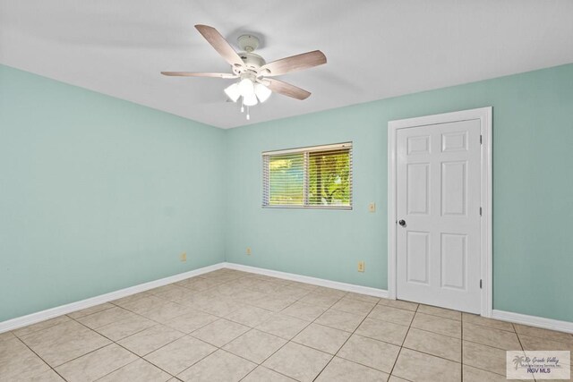 unfurnished room with light tile patterned floors and ceiling fan