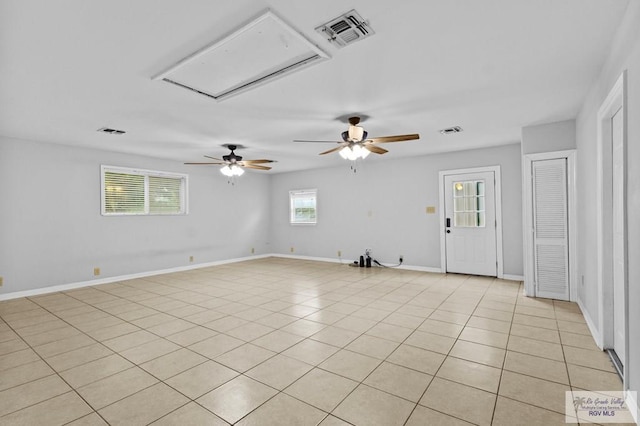 spare room with ceiling fan and light tile patterned floors