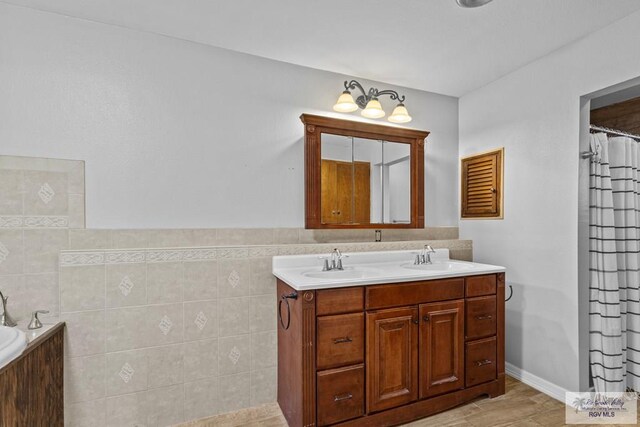 bathroom with shower with separate bathtub, vanity, tile walls, and hardwood / wood-style floors