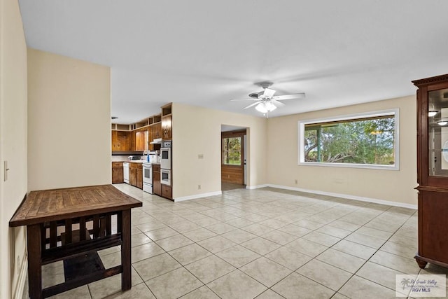 unfurnished living room featuring ceiling fan and light tile patterned flooring