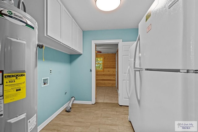 clothes washing area featuring cabinets, washer hookup, electric water heater, light hardwood / wood-style floors, and wood walls