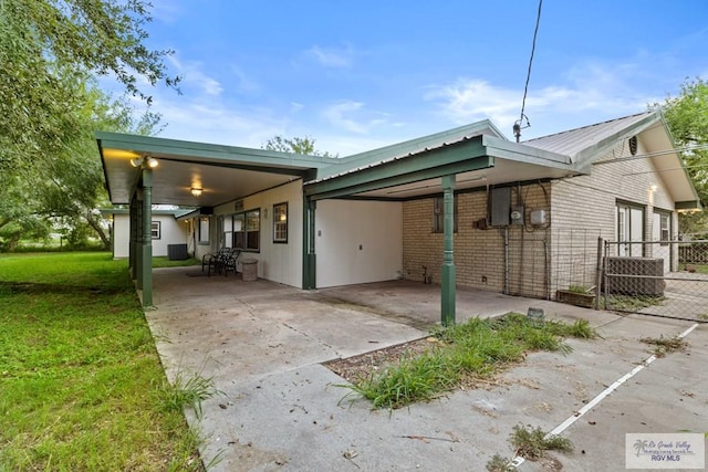 view of side of property with a yard and a carport