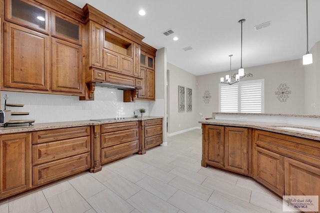 5706 Spicewood, Harlingen, TX 78552 - kitchen featuring brown cabinets, backsplash, a chandelier, hanging light fixtures, and recessed lighting
