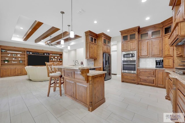 5706 Spicewood, Harlingen, TX 78552 - kitchen with appliances with stainless steel finishes, open floor plan, a peninsula, a breakfast bar area, and tasteful backsplash