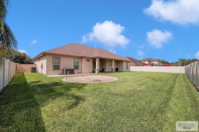 5706 Spicewood, Harlingen, TX 78552 - rear view of house with stucco siding and a fenced backyard