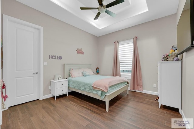 5706 Spicewood, Harlingen, TX 78552 - bedroom featuring wood finished floors, a raised ceiling, and ceiling fan