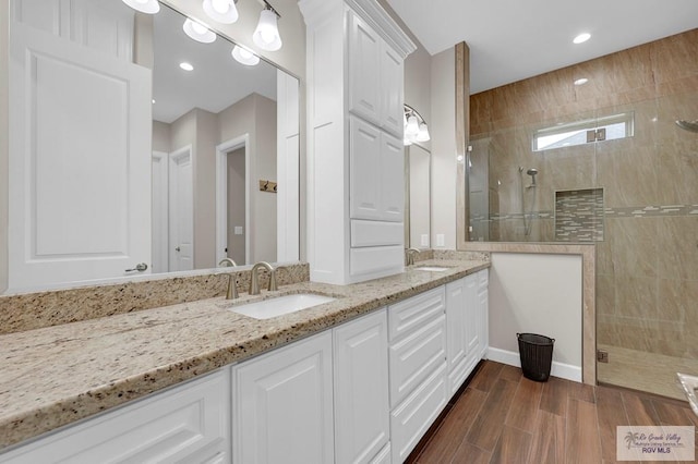 5706 Spicewood, Harlingen, TX 78552 - bathroom featuring double vanity, tiled shower, recessed lighting, and wood finished floors