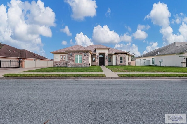5706 Spicewood, Harlingen, TX 78552 - mediterranean / spanish-style house with stone siding, a gate, and stucco siding