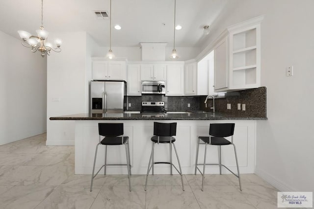 110 E Retama St, South Padre Island, TX 78597 - kitchen featuring stainless steel appliances, open shelves, a peninsula, and light marble finish flooring