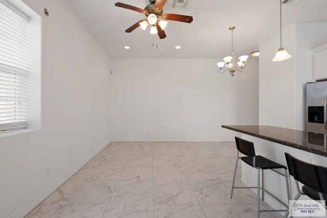 110 E Retama St, South Padre Island, TX 78597 - kitchen with stainless steel fridge with ice dispenser, light marble finish floors, a ceiling fan, white cabinets, and recessed lighting
