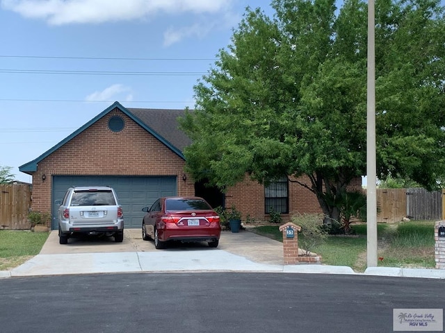 35 Yucatan Ct, Brownsville, TX 78526 - view of front facade featuring brick siding, fence, driveway, and a garage