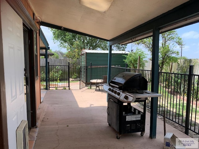 35 Yucatan Ct, Brownsville, TX 78526 - view of patio / terrace with area for grilling, a fenced backyard, and an outbuilding