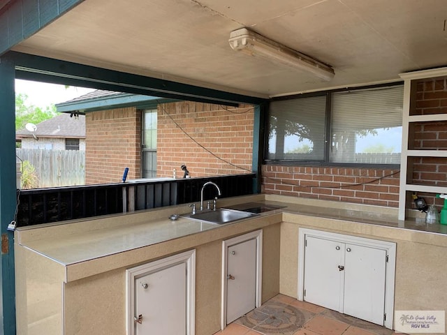 35 Yucatan Ct, Brownsville, TX 78526 - kitchen featuring a sink, white cabinetry, and light countertops