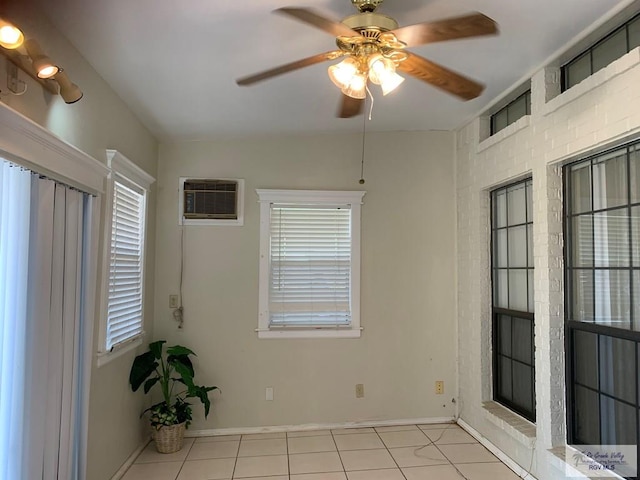 35 Yucatan Ct, Brownsville, TX 78526 - unfurnished room with light tile patterned floors, ceiling fan, a wall unit AC, and baseboards