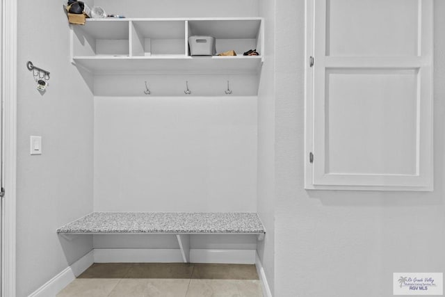 mudroom featuring light tile patterned flooring and baseboards