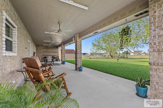 view of patio / terrace with ceiling fan and fence