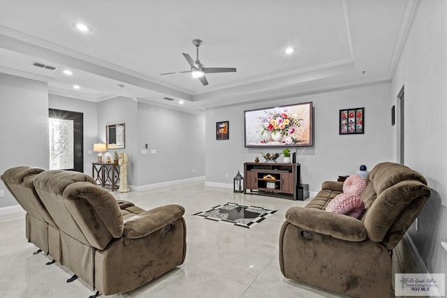 living area featuring ornamental molding, a tray ceiling, visible vents, and baseboards