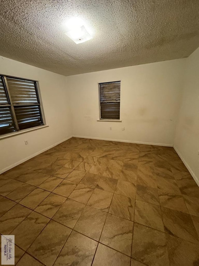 empty room featuring a textured ceiling