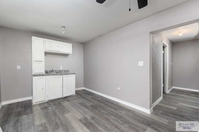 136 Garden St, Brownsville, TX 78520 - kitchen featuring dark wood-type flooring, white cabinets, and baseboards