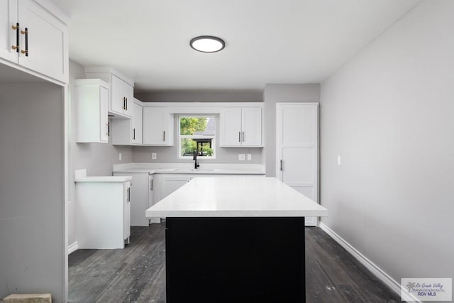 136 Garden St, Brownsville, TX 78520 - kitchen with dark wood-style floors, a center island, white cabinets, and a sink