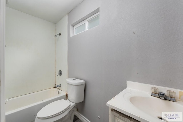 136 Garden St, Brownsville, TX 78520 - bathroom with toilet, vanity, shower / bathtub combination, and baseboards