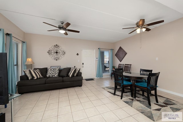 tiled dining space with ceiling fan