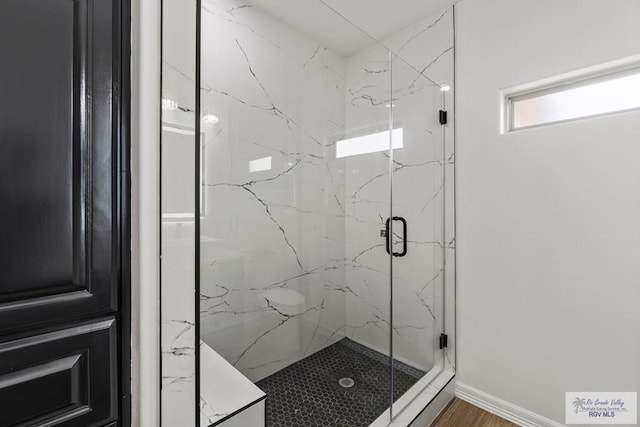 bathroom with a shower with door