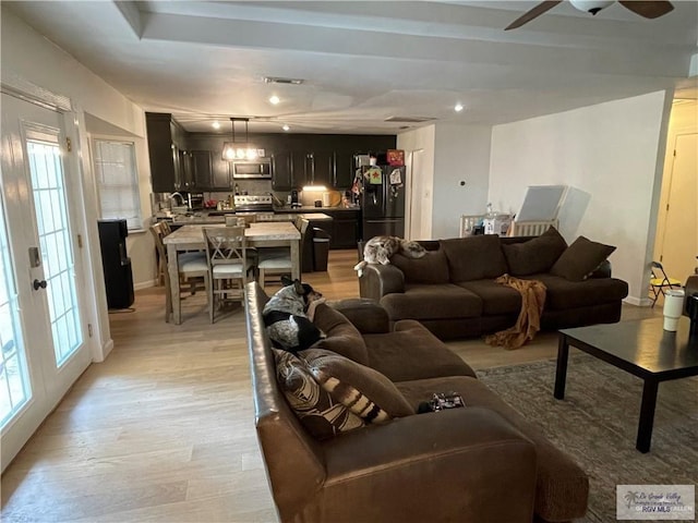 living room featuring ceiling fan and light wood-type flooring