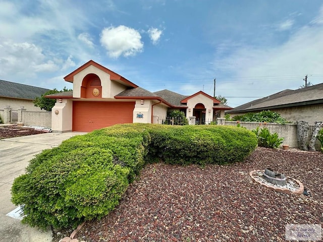 114 Willow Cir, Harlingen, TX 78552 - ranch-style home with stucco siding, concrete driveway, and an attached garage