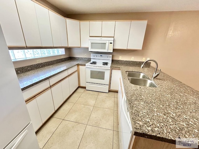 114 Willow Cir, Harlingen, TX 78552 - kitchen with white appliances, a sink, a peninsula, and white cabinetry