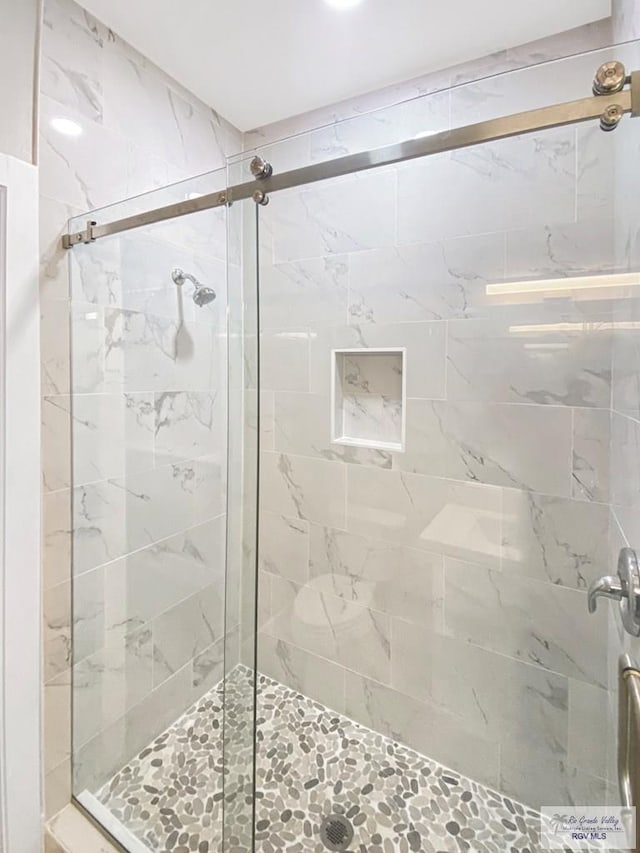 full bath with a shower stall