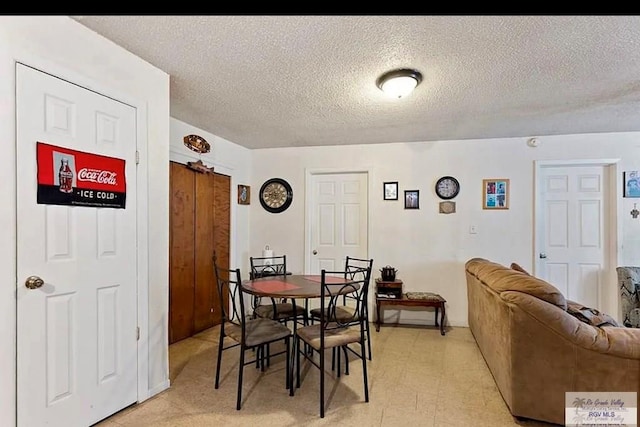 dining area featuring a textured ceiling