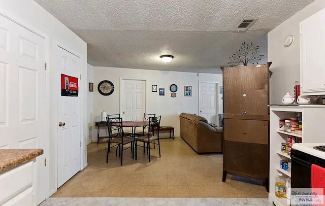 dining room featuring a textured ceiling