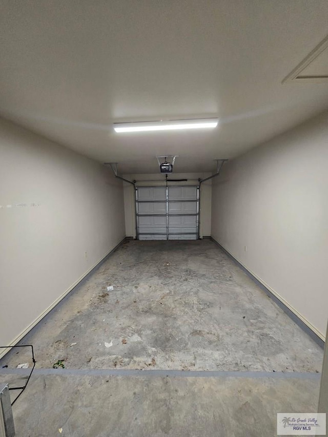garage featuring baseboards and a garage door opener