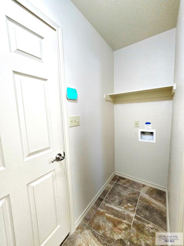 washroom with a textured ceiling, laundry area, baseboards, and hookup for a washing machine