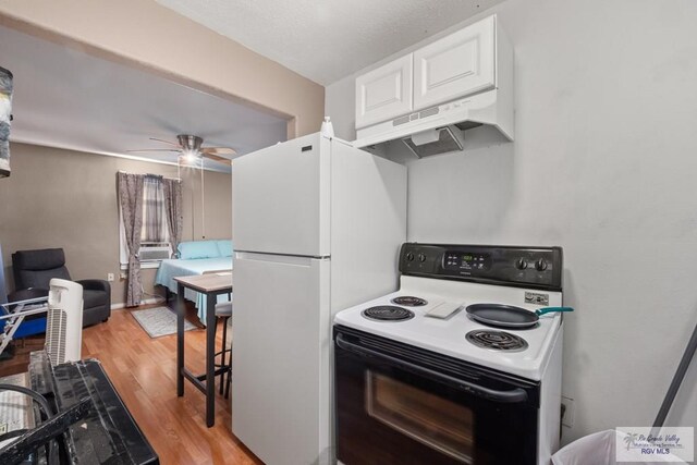 kitchen with white cabinets, ceiling fan, light wood-type flooring, and white appliances