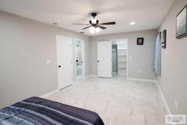 bedroom featuring a spacious closet, recessed lighting, a ceiling fan, and baseboards