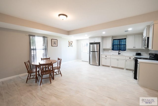 dining room featuring recessed lighting and baseboards