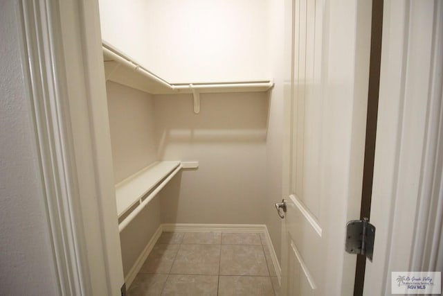 spacious closet featuring light tile patterned flooring