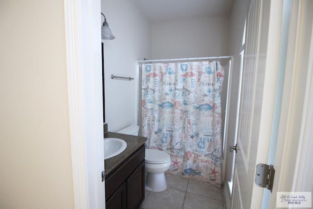 bathroom featuring tile patterned flooring, vanity, and toilet