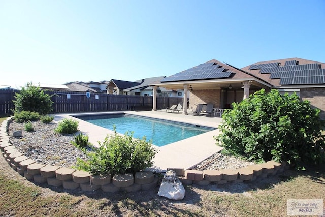 view of swimming pool with a patio and ceiling fan